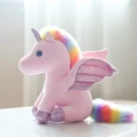 peluche licorne ailé rose assise de côté